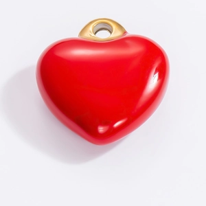 Vibrant red heart-shaped stainless steel pendant with gold ring on grey background