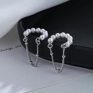Elegant gold-plated ear cuff with white pearls and hanging silver tassel chains