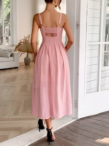 Detail view of the elegant open-back and pleated hemline of this pink A-line midi dress