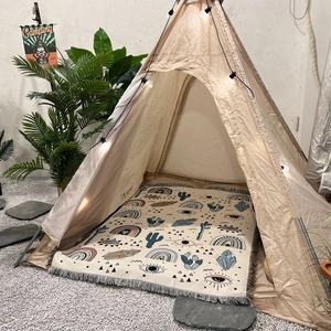 Bohemian camping blanket with rainbow cactus patterns in a cozy tent setting