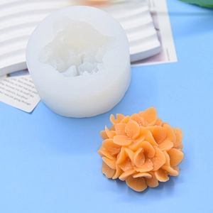 Carnation flower scented candle silicone mold with orange floral wax craft on blue background