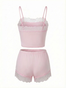 Detail view of pink satin camisole set featuring delicate lace trim and adjustable straps
