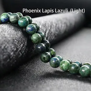 Macro detail of natural Phoenix Lapis beads showing blue and green marble textures