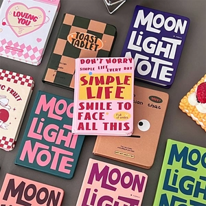 Colorful A7 mini grid notebooks with cartoon motifs and motivational text on covers