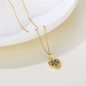 Gold stainless steel heart necklace with black enamel flower and zircon inlay details