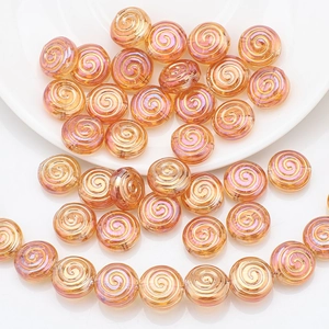 Macro detail of spiral round crystal glass beads in golden pink for DIY jewelry making