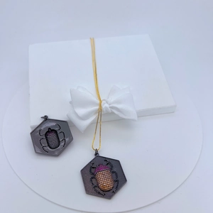 Copper micro-inset beetle necklace pendants with purple and orange crystals in a gift box