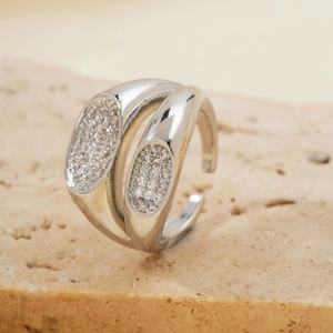 Detailed view of silver double-layered crisscross ring with micro-pave zircons on a stone