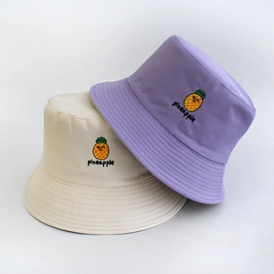 Detail of colorful pineapple embroidery and high-quality fabric on reversible bucket hats