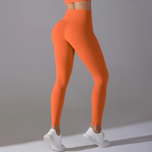 Detail view of high-waisted orange yoga leggings featuring seamless V-shaped butt lift seams
