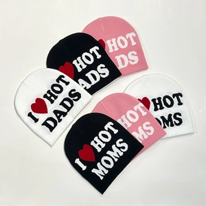 Flat lay of knit beanies in black white and pink with I Heart Hot Dads text pattern