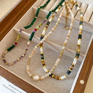 Detail of freshwater pearl and shell bead necklaces with gold plating in a jewelry box