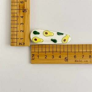 Sparkly avocado fruit hair clip for girls with size measurements on white background