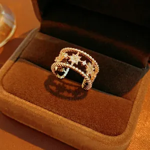 Luxury gold star double-layered open ring with cubic zirconia in a velvet jewelry box