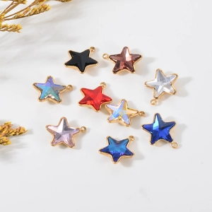 Close-up of assorted gold-plated stainless steel star pendants with colorful glass crystals