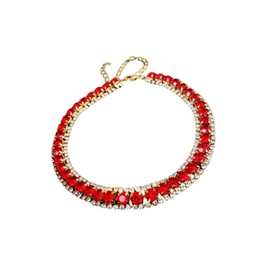 Elegant gold necklace with red square gemstones and clear diamonds on white background