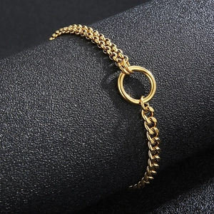 Detailed close-up of mixed texture gold chain bracelet with beads and flat curb links