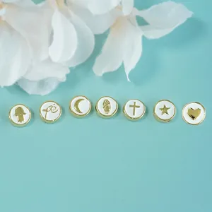 Enamel cross and hamsa hand bead charms set for bracelet making on blue background