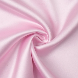 Close-up of pink satin fabric texture with elegant silky folds and glossy finish