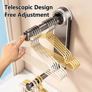 Wall-mounted retractable clothes drying rack with grey metal bracket and hangers