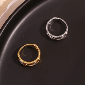 Detailed view of intertwined wave rings with sparkling crystal pavé in gold and silver