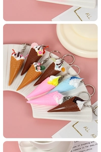 Detailed shot of assorted mini ice cream cone keychains with sprinkles on a white plate