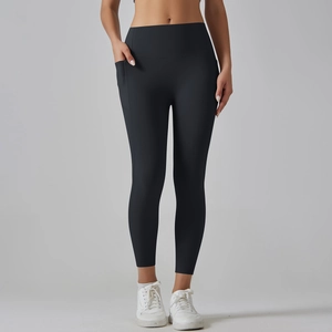 Detail of high-waisted black yoga leggings featuring a functional side phone pocket