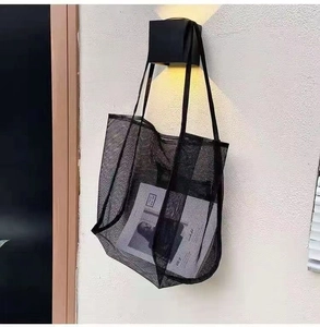 Detail of black mesh tote bag showing breathable nylon texture and sturdy shoulder straps