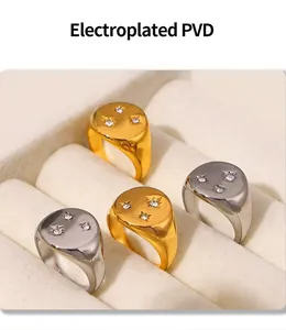 Macro detail of gold and silver PVD rings with three inlaid diamonds in a jewelry box