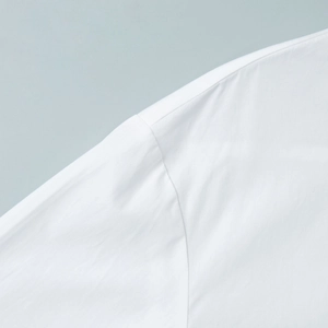 Detailed view of fine stitching and fabric texture on a white ruffle stand-collar shirt