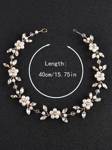Detailed shot of 40cm handmade pearl and rhinestone bridal hair chain on dark background