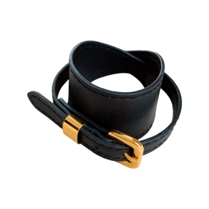 Minimalist black faux leather rectangular bracelet with a polished gold buckle closure