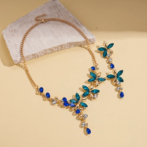 Parure bijoux vintage dorée avec collier fleur en cristal bleu et boucles d'oreilles