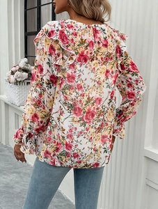Rear view of long-sleeved floral blouse for women featuring pink flowers and ruffled details
