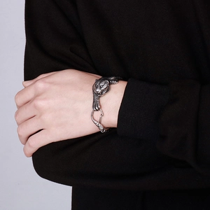 Close-up of vintage silver tiger head steel chain bracelet on male wrist