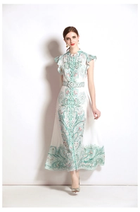 Detail of floral printed dress featuring ruffled cuffs and a matching waist belt