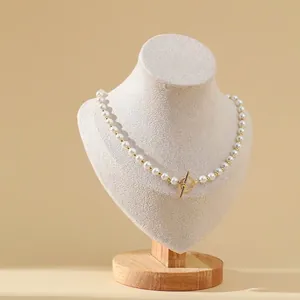 Elegant freshwater pearl necklace with gold spacers and toggle clasp on display stand