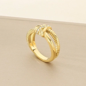 Detail of 18K gold-plated irregular knotted ring featuring shimmering teardrop crystals