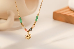 Detail of 18K gold stainless steel sun pendant necklace with colorful natural stone beads