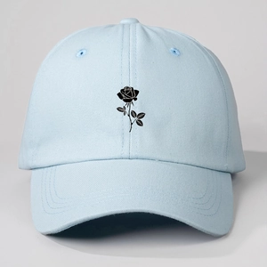Detail of light blue baseball cap featuring a black rose floral print design