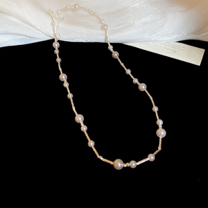 Macro detail of French Manta rose pearl necklace with adjustable metal chain clasp