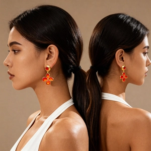 Vintage gold metal earrings with red enamel flower charms shown on a female model