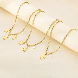 Detailed close-up of gold stainless steel necklaces with boy and girl pendants and pearls
