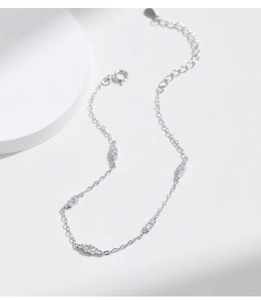 Macro shot of minimalist S925 sterling silver bracelet with sparkling zircon stones