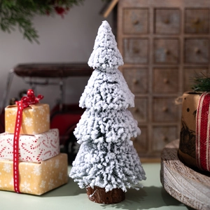 Miniature cedar Christmas tree with fake snow and round wooden base for desktop decor