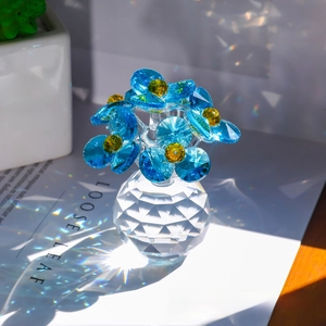 Macro shot of blue crystal flower sculpture with light refraction on a clear base