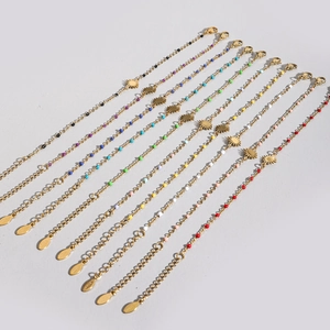 Detail of colorful enamel bead bracelets with starburst charms and gold stainless steel