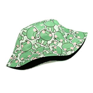 Detail of cute frog pattern on green bucket hat with flat seams and black lining