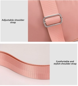 Detail of adjustable pink nylon shoulder strap with polished silver metal buckle for comfort