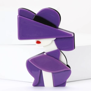 Detailed view of an acrylic brooch featuring a lady in a purple hat and red lips profile